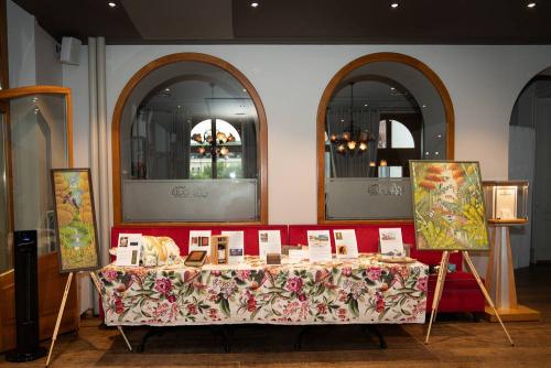 Auction table, Haitian paintings